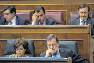  ?? AP PHOTO ?? In this file photo, Spain’s Prime Minister and Popular Party leader Mariano Rajoy, lower row right, and Deputy Prime Minister Soraya Saenz de Santamaria attend the national budget debate at the Spanish parliament in Madrid. Spain’s Prime Minister...