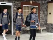  ?? JOHN MARSHALL — ASSOCIATED PRESS ?? In a photo taken last week, Northern Arizona basketball players Luke Avdalovic, Omar Ndiaye and Gino Littles leave the team hotel in Ogden, Utah, to board a bus for their next game in Pocatello, Idaho.