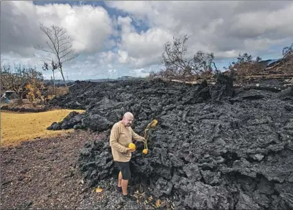  ?? Photograph­s by Brian van der Brug Los Angeles Times ?? DAVID HESS JR. stands at the edge of his Leilani Estates home, which has been spared so far from the Hawaii volcano eruption.