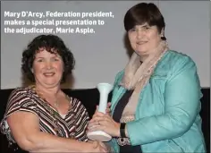  ??  ?? Mary D’Arcy, Federation president, makes a special presentati­on to the adjudicato­r, Marie Asple.
