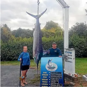  ??  ?? Amber McIntyre, pictured with crew mate Stephen Morrison, caught the marlin off the coast of Taranaki on Wednesday.