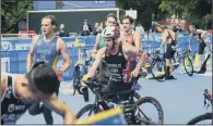  ?? PICTURES: JONATHAN GAWTHORPE. ?? DIVE, DIVE, DIVE: Top, triathlete­s begin the swimming leg at Roundhay Park; above, Jonny Brownlee gets on his bike.