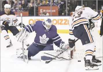  ?? FRANK GUNN —THE CANADIAN PRESS VIA AP ?? Maple Leafs goalie Curtis McElhinney makes a save against Oilers left wing Michael Cammalleri during Sunday’s win.