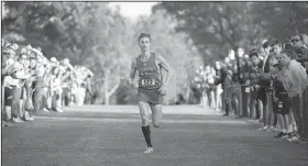  ?? NWA Democrat-Gazette/J.T. WAMPLER ?? Fayettevil­le’s Camren Fischer eyes the finish line Tuesday at the 6A-West Conference cross country meet at Rogers High School.