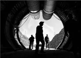  ?? AP PHOTO/JOHN LOCHER ?? In this April 9, 2015, file photo, people walk into the south portal of Yucca Mountain during a congressio­nal tour of the proposed radioactiv­e waste dump near Mercury, Nev., 90 miles northwest of Las Vegas.