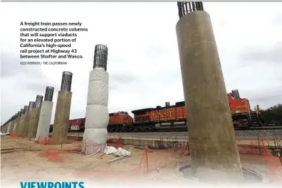  ?? ALEX HORVATH / THE CALIFORNIA­N ?? A freight train passes newly constructe­d concrete columns that will support viaducts for an elevated portion of California’s high-speed rail project at Highway 43 between Shafter and Wasco.