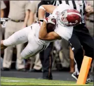 ?? AP/DAVID J. PHILLIP ?? Alabama defensive back Vinnie Sunseri dives over the goal line after returning an intercepti­on 73 yards off Texas A&M’s Johnny Manziel for a third-quarter touchdown in a 49-42 victory.
