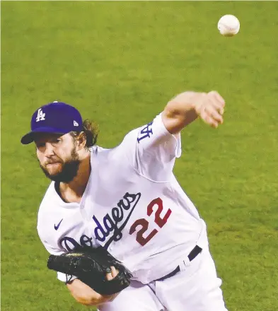  ?? HARRY HOW / GETTY IMAGES ?? Los Angeles Dodgers veteran ace Clayton Kershaw closed out the Milwaukee Brewers
with a career-high 13 strikeouts over eight innings in a 3-0 victory.