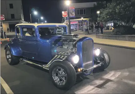  ?? PHOTOS COURTESY OF LANSDALE CRUISE NIGHT ?? Spectators watch as a classic car rolls down Madison Street near Main Street in Lansdale during a socially-distanced Lansdale Cruise Night on Saturday.