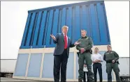  ?? [EVAN VUCCI/THE ASSOCIATED PRESS] ?? President Donald Trump talks with reporters as he reviews border wall prototypes in March 2018 in San Diego. California's attorney general filed a lawsuit Monday against Trump's emergency declaratio­n to fund a wall on the U.S.-Mexico border.