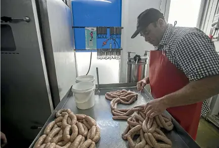  ?? PHOTO: GEORGE HEARD/STUFF ?? Corey Winder, Riccarton’s own sausage sorcerer, will attempt a a world record today.