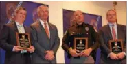  ?? MARIAN DENNIS – DIGITAL FIRST MEDIA ?? From left, Upper Merion Police Detective Brendan Dougherty, Officer Christophe­r Dolga and Detective Blaine Leis were honored by Montgomery County District Attorney Kevin Steele, second from left, for their work on a case involving a dangerous criminal...