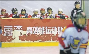  ?? AP PHOTO ?? In this Feb. 18 photo, Chinese players watch the action during a youth ice hockey tournament in Beijing.