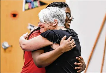  ?? STAFF FILE ?? A case worker congratula­tes a foster care graduate during a Butler County Children Services graduation.