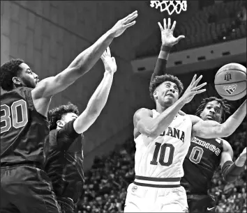  ?? DARRON CUMMINGS/AP ?? Indiana’s Rob Phinisee (10) puts up a shot against Portland State’s Chris Whitaker (30), Markus Golder (2) and Sal Nuhu (0) on Saturday.