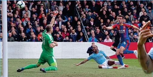  ??  ?? Slide rule: Sterling (grounded) opens the scoring for City to continue his great recent run of form for the champions