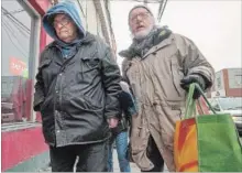  ?? RYAN REMIORZ THE CANADIAN PRESS ?? Residents leave a condemned apartment building after being evicted Thursday in Montreal. Tenants of two decrepit buildings in the neighbourh­ood received evacuation notices three weeks ago.