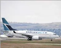  ?? CP PHOTO ?? WestJet planes are seen at the Calgary Airport earlier this month in Calgary, Alta.