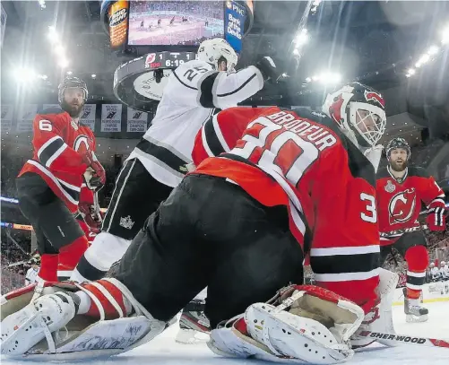  ?? BRUCE BENNETT, GETTY IMAGES ?? Los Angeles Kings forward Dustin Penner celebrates Jeff Carter’s game-winning goal in overtime as New Jersey Devils goalie Martin Brodeur, defenceman Andy Greene, left, and Stephen Gionta look on at the Prudential Center in Newark, N. J., on Saturday.