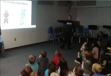  ?? MELISSA SCHUMAN - MEDIANEWS GROUP ?? School Resource Officer Marie Abraham talks Halloween safety with Red Mill Elementary School’s second graders.