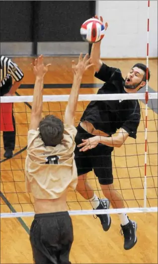  ?? GENE WALSH — DIGITAL FIRST MEDIA ?? Christophe­r Dock’s Ryan Class spikes over a Bethlehem Catholic defender.