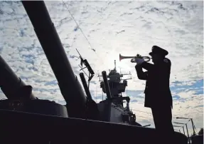  ?? N.J. MATT ROURKE/AP ?? Greg Murphy plays the Navy Hymn last year during a ceremony commemorat­ing the 75th anniversar­y of the attack on Pearl Harbor, on board the battleship New Jersey Museum and Memorial in Camden,