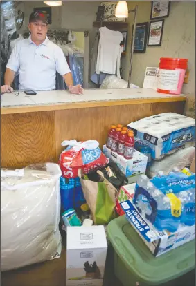  ?? BEA AHBECK/NEWS-SENTINEL ?? Owner Dean Machado talks about donations for victims of the Camp Fire that people have dropped off at his business, Woodlake Cleaners in Lodi on Wednesday.