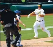  ??  ?? Oakland’s Matt Chapman rushes home to score the tying run in the ninth inning against the Dodgers.