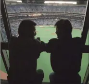  ?? RUSTY KENNEDY - ASSOCIATED PRESS ?? In this Oct. 22, 1992, file photo, spectators look out at the field of the SkyDome in Toronto, from a window of the SkyDome Hotel before Game 5 of the World Series between the Toronto Blue Jays and the Atlanta Braves.