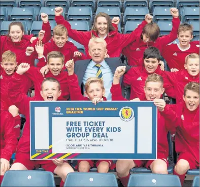  ??  ?? THE KIDS ARE ALL RIGHT: Scotland manager Gordon Strachan gets help promoting the upcoming qualifier against Slovakia at Hampden.