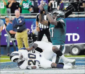  ?? Mark J. Terrill ?? The Associated Press Eagles wide receiver Alshon Jeffery catches a touchdown pass over Los Angeles Rams free safety Lamarcus Joyner in the third quarter of Philadelph­ia’s 43-35 victory Sunday.