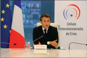  ??  ?? French President Emmanuel Macron participat­es in a videoconfe­rence with regional officials earlier this week in Paris as France began lifting confinemen­t measures.
(AP/Ludovic Marin)