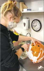  ?? Submitted/LONNIE MOLL ?? Josie Newsom, a student in the CNA/PCA classes at Gentry High School, practices her patient-care skills by shaving a balloon. Before shaving a person, students practiced by shaving a balloon.