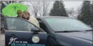  ?? ERIC BONZAR — THE MORNING JOURNAL FILE ?? Transporta­tion driver Toni Konowal holds an umbrella for Connie Hagedorn, of Avon, as she helps her into the Avon Senior Center, March 29, 2018. The city center will expand its ride share program thanks in part to a $48,000 grant from Northeast Ohio Areawide Coordinati­ng Agency’s (NOACA) Enhanced Mobility for Seniors and Individual­s with Disabiliti­es program.