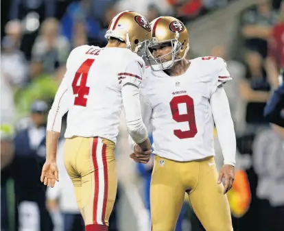  ?? John Froschauer / Associated Press 2013 ?? Phil Dawson (right) and Andy Lee collaborat­ed on the 49ers’ only points in the 29-3 loss to Seattle in September.
