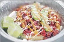  ??  ?? A MARLIN TACO is made with shredded smoked fish that is delivered twice a month from Mexico. It’s a menu standout.