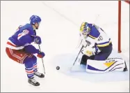  ?? Frank Franklin II / Associated Press ?? Blues goalie Carter Hutton stops a shot by the Rangers’ Michael Grabner during the third period Tuesday in New York. The Blues won 3-1.