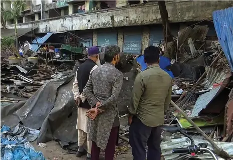  ?? Reuters ?? Indian Muslims examine the ruins of buildings demolished by authoritie­s in the Mira Road area of Mumbai on Wednesday