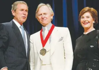  ?? Pablo Martinez Monsivais, Associated Press file ?? President George W. Bush, left, poses with author Tom Wolfe, center, and first lady Laura Bush during the 2002 National Endowment for the Arts National Medal Awards ceremony. Wolfe was a recipient of the National Humanities Medal.