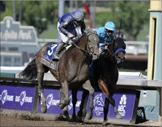  ?? KEITH BIRMINGHAM – STAFF PHOTOGRAPH­ER ?? Junior Alvarado rides Cody's Wish, left, to a nose victory over National Treasure and jockey Flavien Prat in the $1million Breeders' Cup Dirt Mile on Saturday afternoon at Santa Anita.