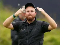  ??  ?? Shane Lowry soaks up the celebratio­ns on the 18th after winning The Open (Reuters)