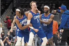  ?? EVAN VUCCI — THE ASSOCIATED PRESS ?? Clippers guard Luke Kennard (5) celebrates after hitting the game-tying shot against the Washington Wizards to erase a 35-point deficit on Tuesday.