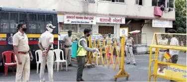  ?? Associated Press ?? ↑
A civic worker sanitises an area near a barricade in Worli, Maharasthr­a, on Tuesday.