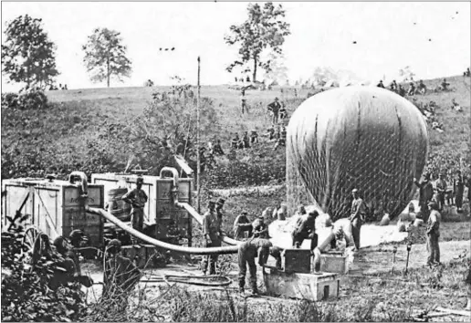  ?? PHOTO COURTESY OF THE LIBRARY OF CONGRESS ?? Lowe’s balloon being inflated near Richmond, Va., in preparatio­n for a launch. Note the portable generator, invented and constructe­d by Lowe, used to inflate the bag. This generator made it possible to inflate bags in the field instead of sending the...