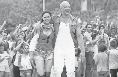  ?? UNIVERSAL ?? When Michelle Rodriguez and Vin Diesel were filming the barbecue scene for The Fate of the Furious, “That was the only time I wasn’t strong enough to keep it together ( that the late Paul Walker wouldn’t be attending),” Diesel says.