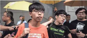  ?? FILE PHOTO BY PHILIPPE LOPEZ, AFP/GETTY IMAGES ?? Pro-democracy activist Joshua Wong, left, shown here in 2015, says, “Autonomy is at a low point in Hong Kong ” right now.