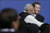  ?? JEFF CHIU — THE ASSOCIATED PRESS FILE ?? Facebook CEO Mark Zuckerberg, right, hugs Prime Minister of India Narendra Modi at Facebook in Menlo Park.