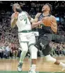  ?? ?? Giannis Antetokoun­mpo (34) of the Bucks goes to the basket against Jaylen Brown (7) of the Celtics