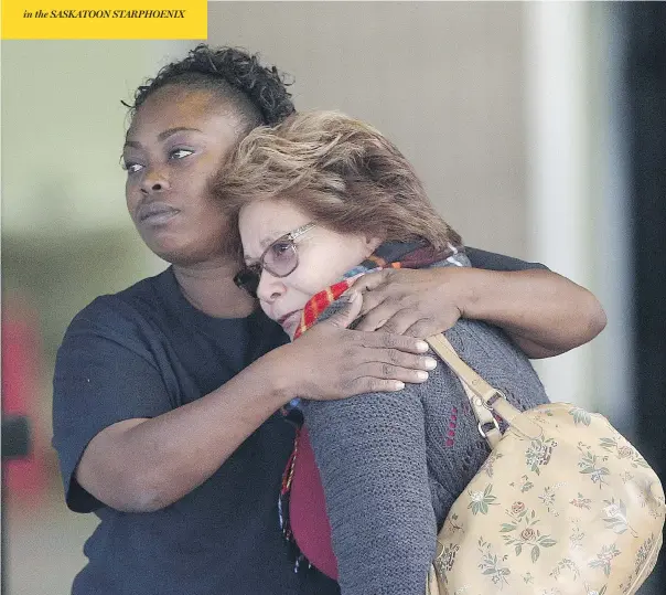  ?? JAE C. HONG / THE ASSOCIATED PRESS ?? Women embrace outside a community centre in San Bernardino, Calif., after three armed people stormed the facility and began shooting at patrons and employees.