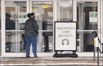  ?? Photos by Lori Van Buren / Times Union ?? A person enters a COVID-19 vaccinatio­n site at the Mcdonough Sports Complex at Hudson Valley Community College in Troy on Thursday.